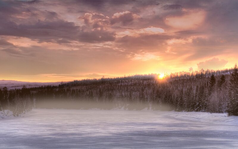 Winter sunset over frozen lake