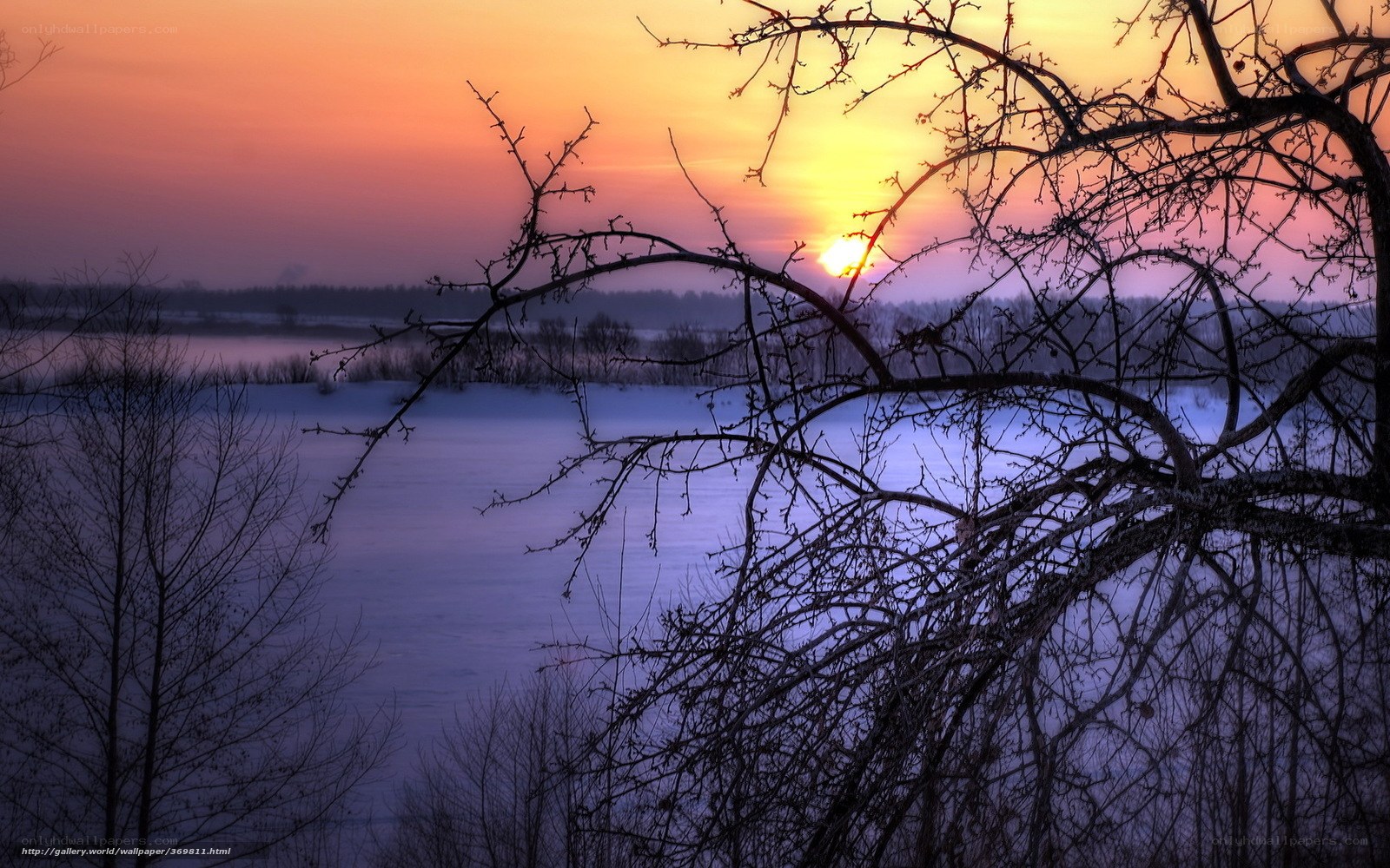 Winter sunset over frozen lake