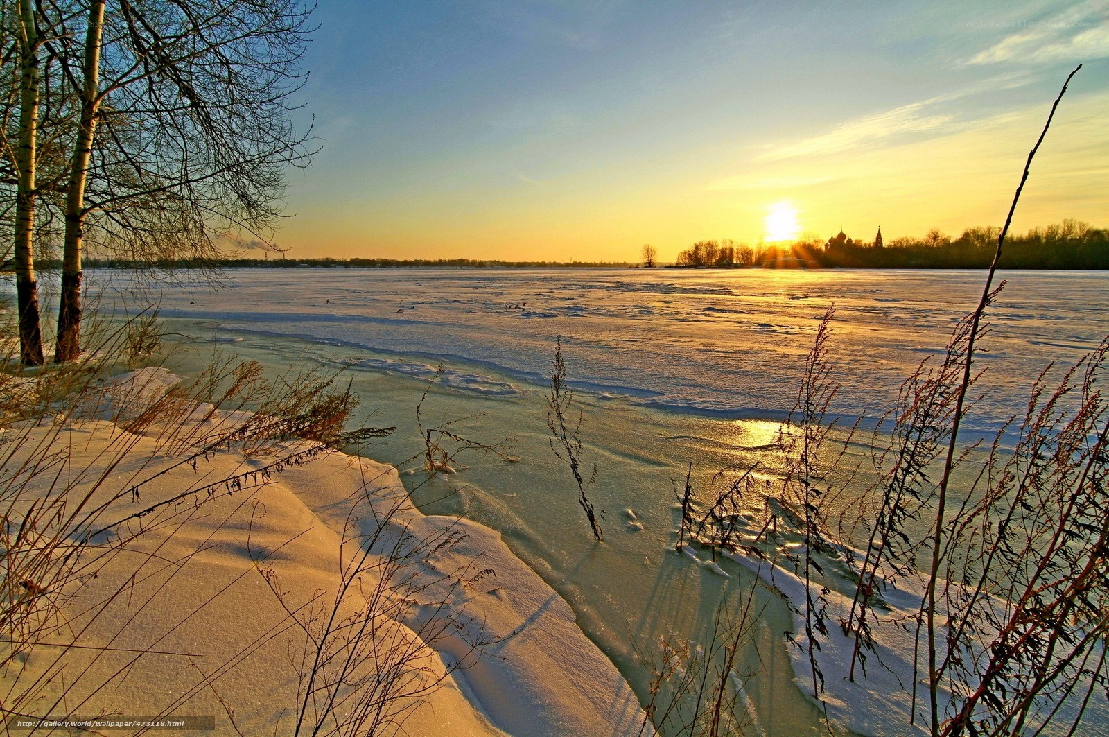 Winter sunset over frozen river