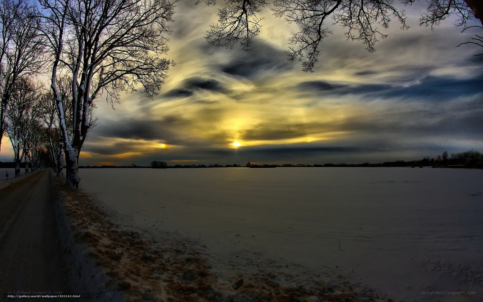 Winter sunset over snow-covered field