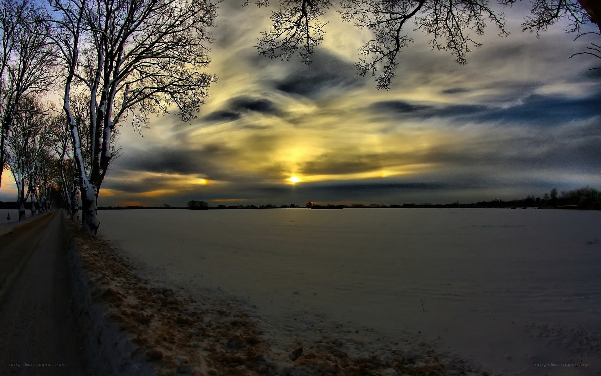 Winter sunset over snowy field