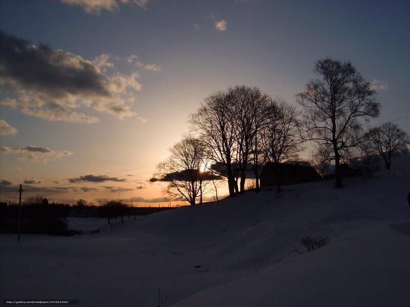 Winter sunset over snowy hill