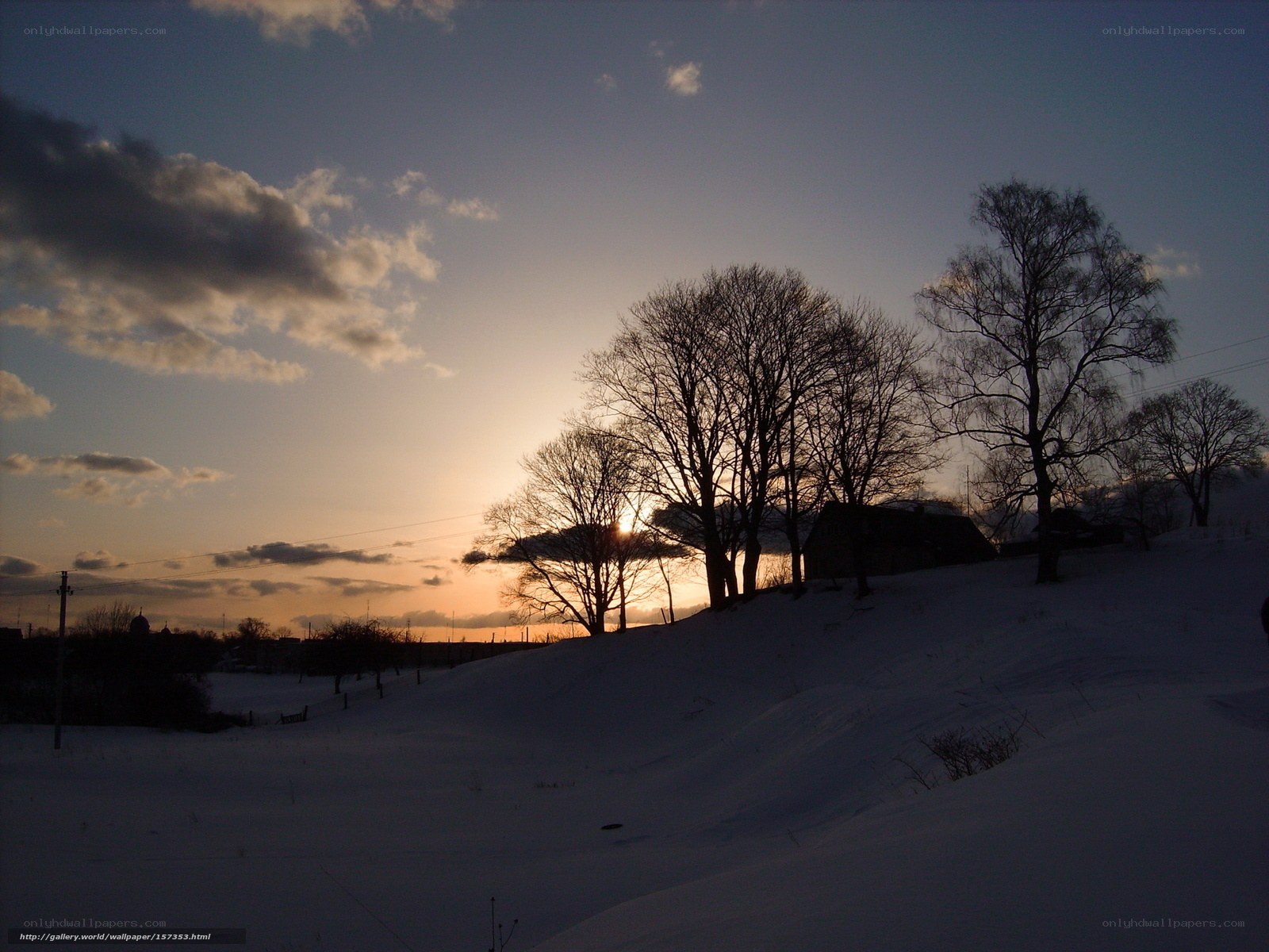 Winter sunset over snowy hill