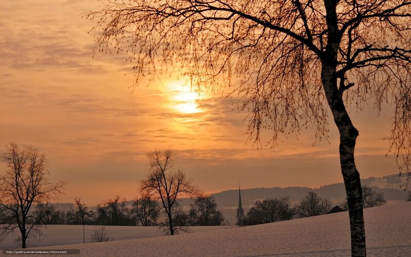 Winter sunset over snowy landscape