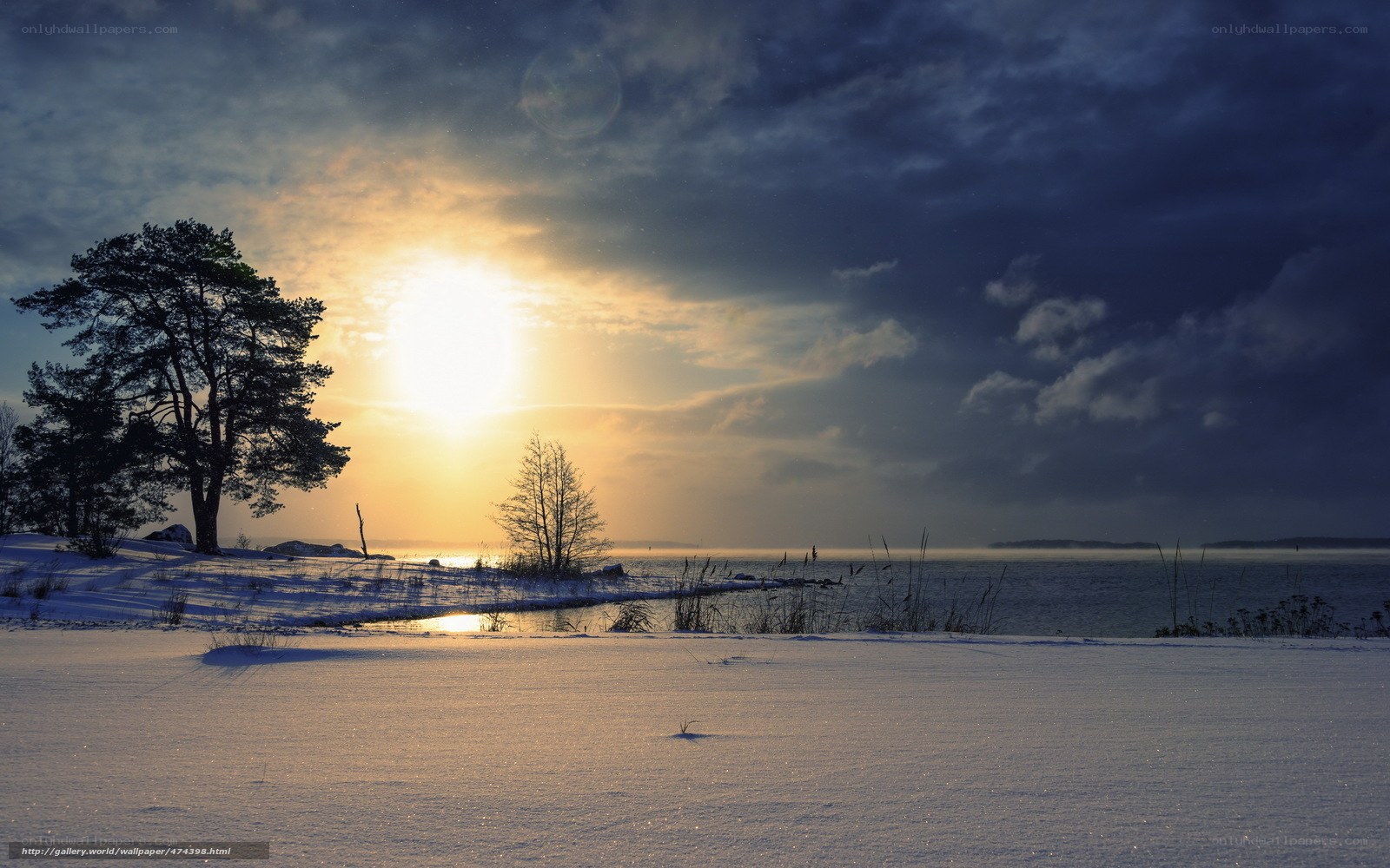 Winter sunset over snowy shore