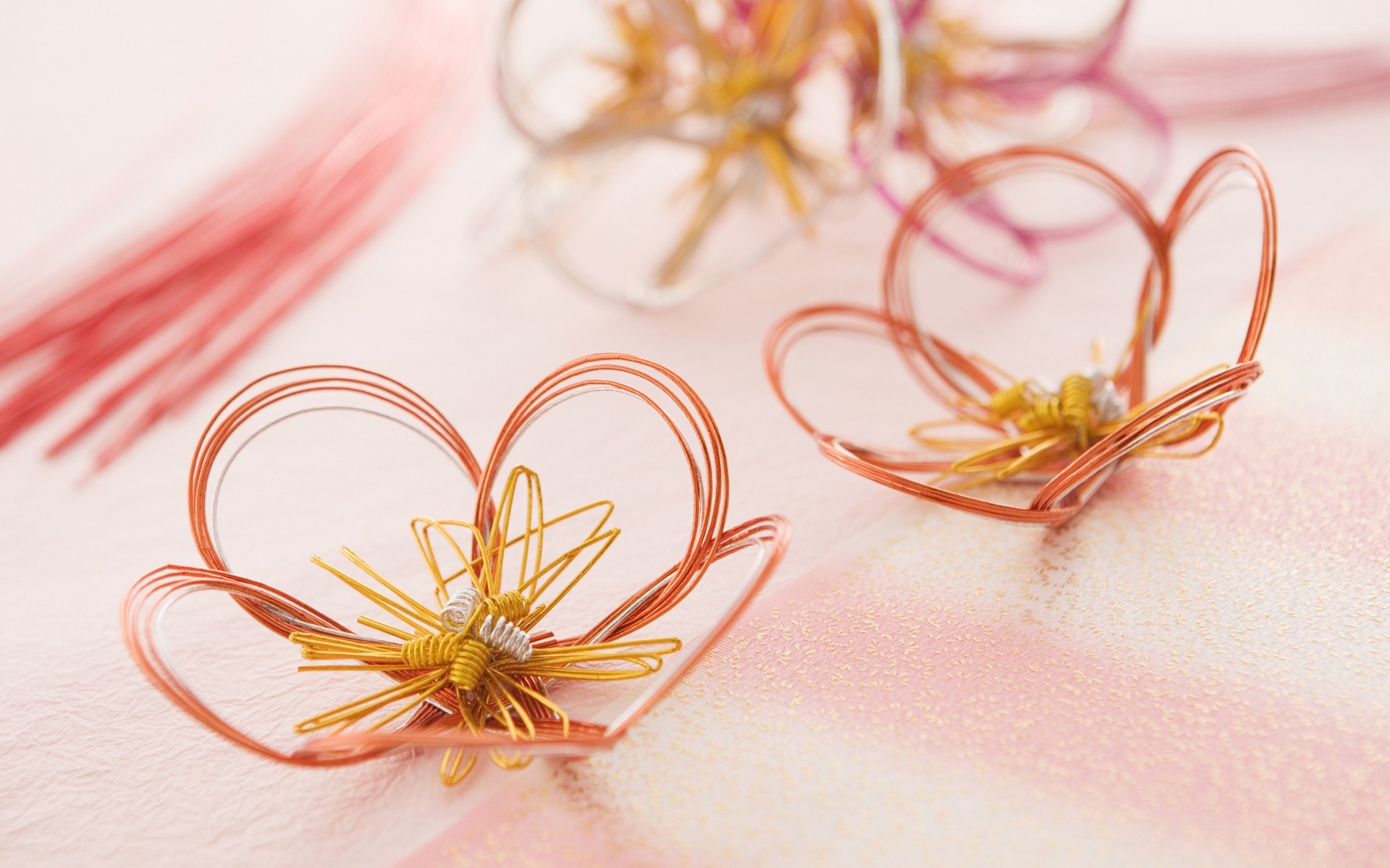 Wire flower crafts on pink paper