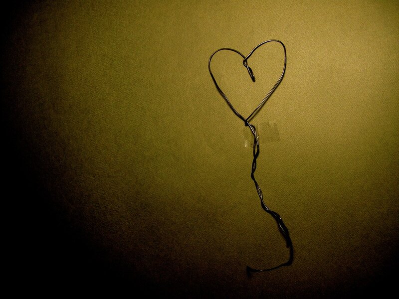 Wire heart on green wall
