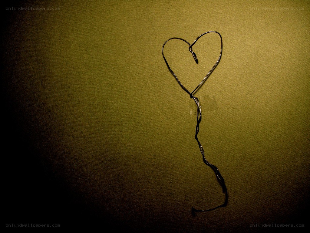 Wire heart on green wall