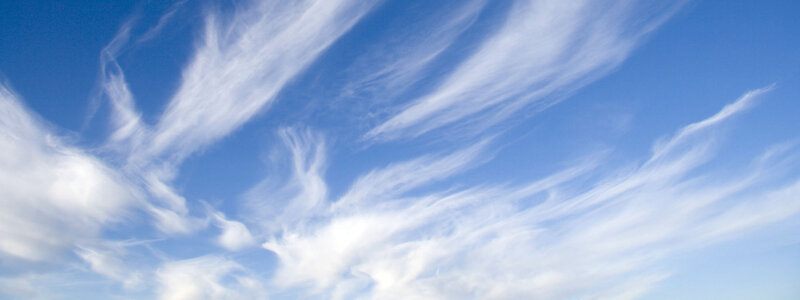 wispy clouds in blue sky