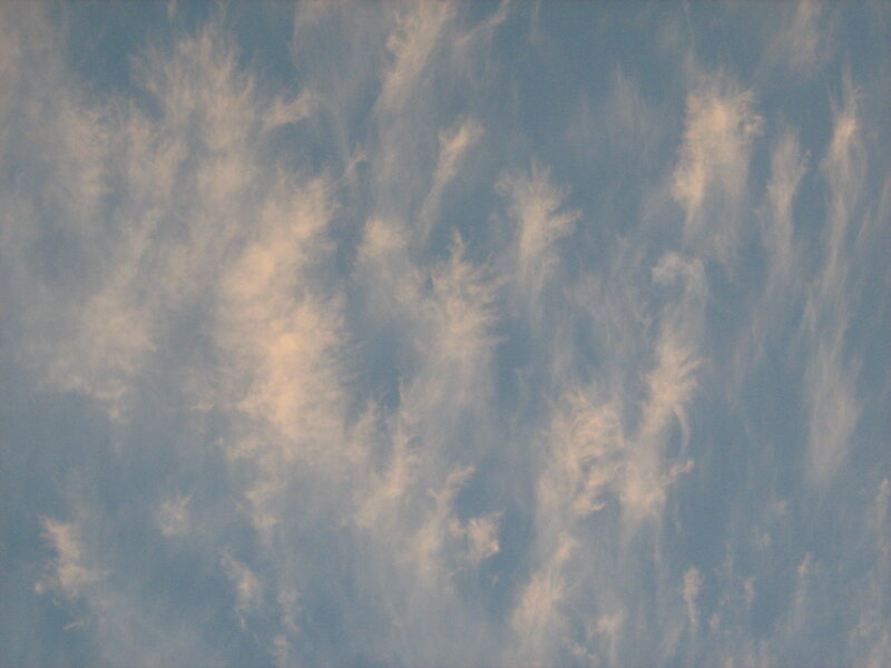 wispy clouds in blue sky