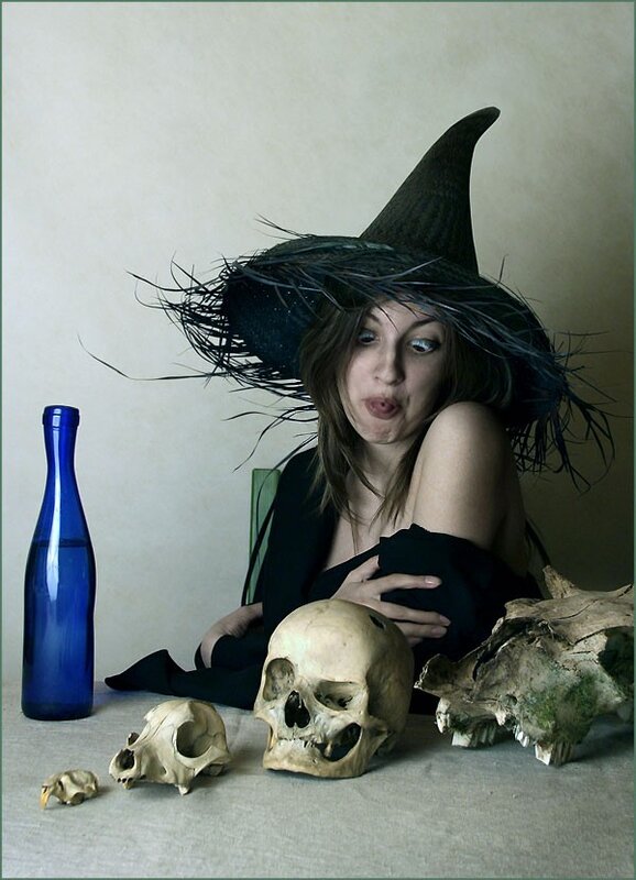 witch with skulls and blue bottle