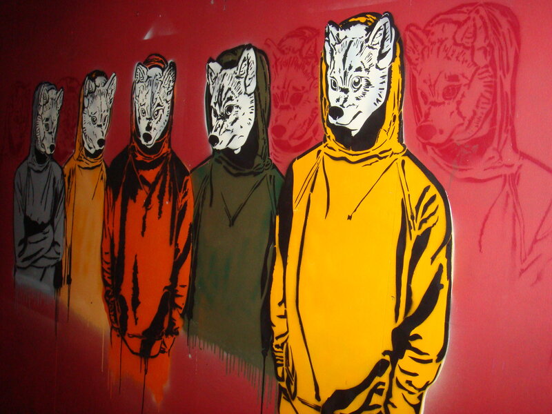 wolf-masked figures in graffiti