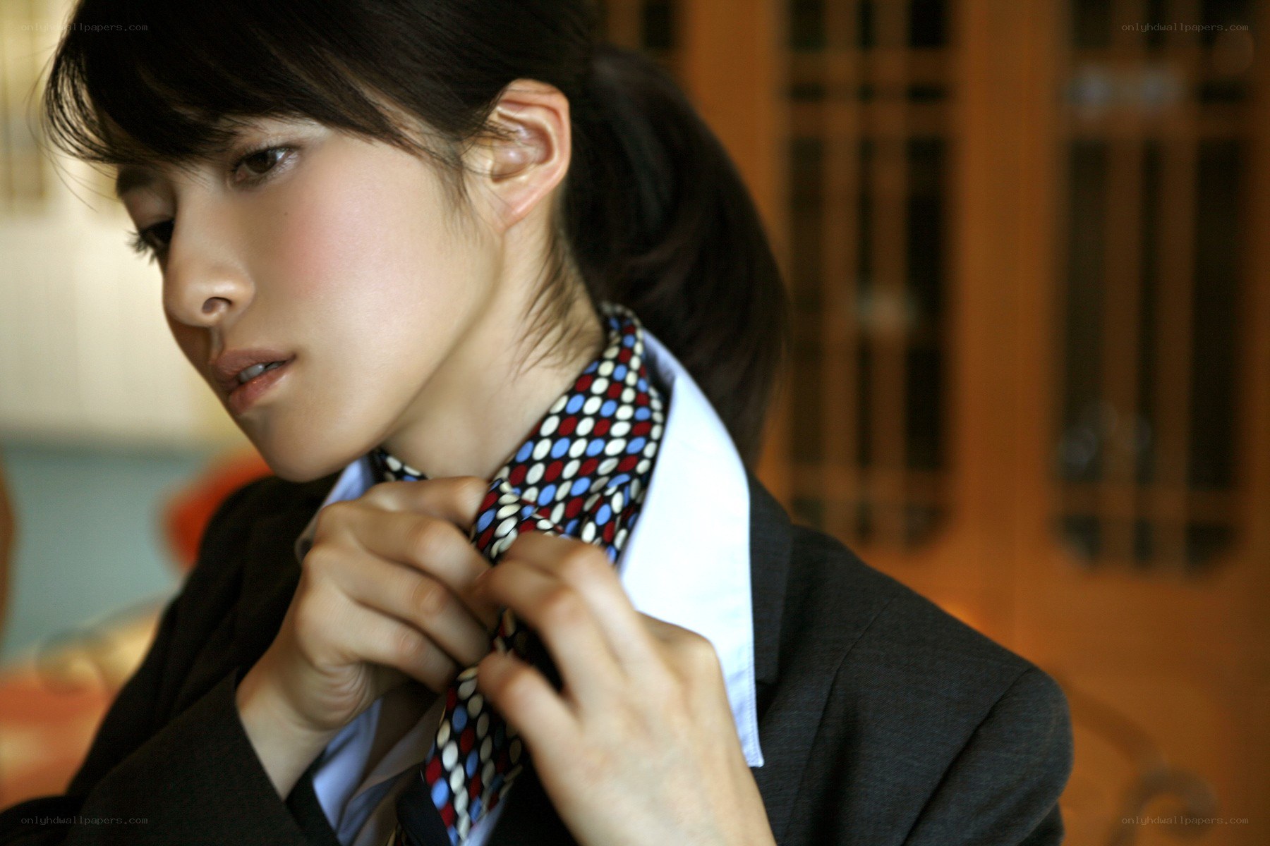 woman adjusting a tie