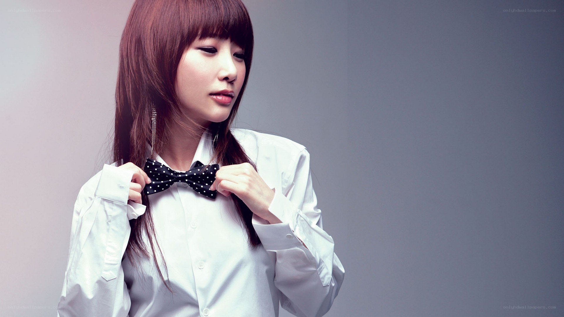 woman adjusting bow tie