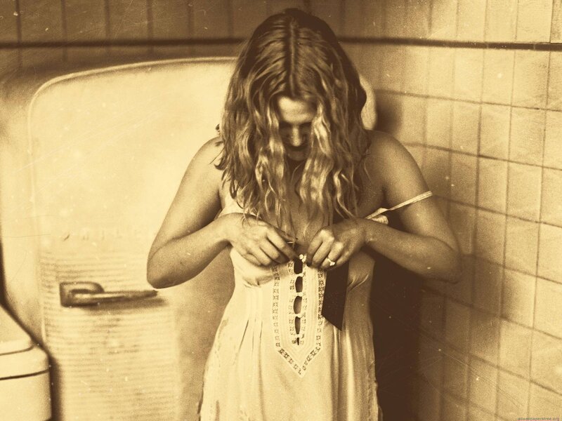 woman adjusting dress in kitchen