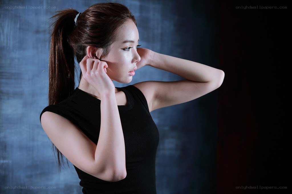woman adjusting ear in studio