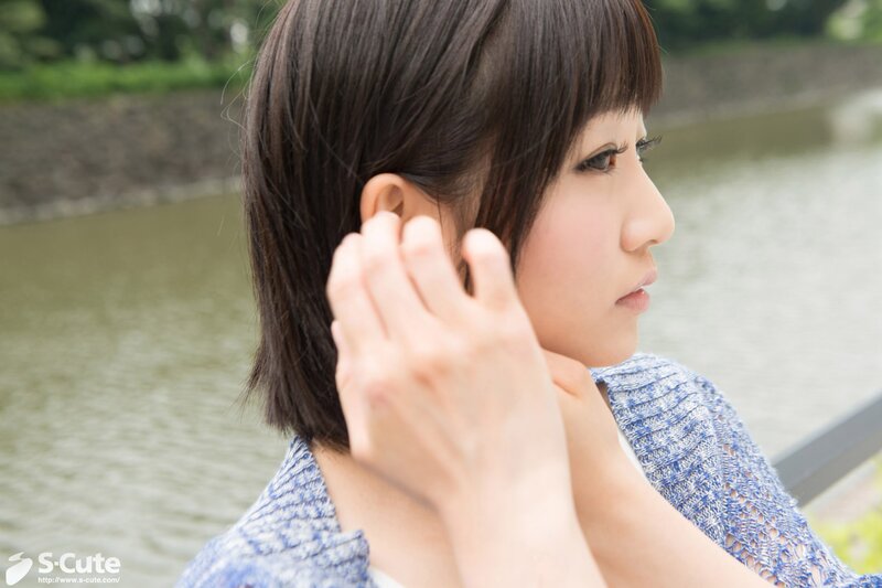 woman adjusting ear outdoors