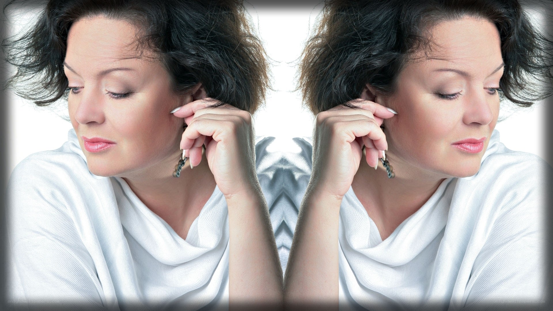 woman adjusting earring