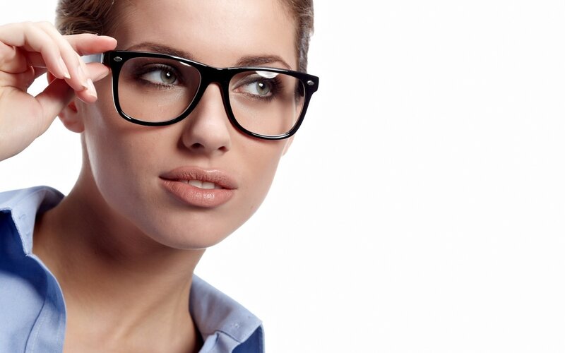 woman adjusting glasses
