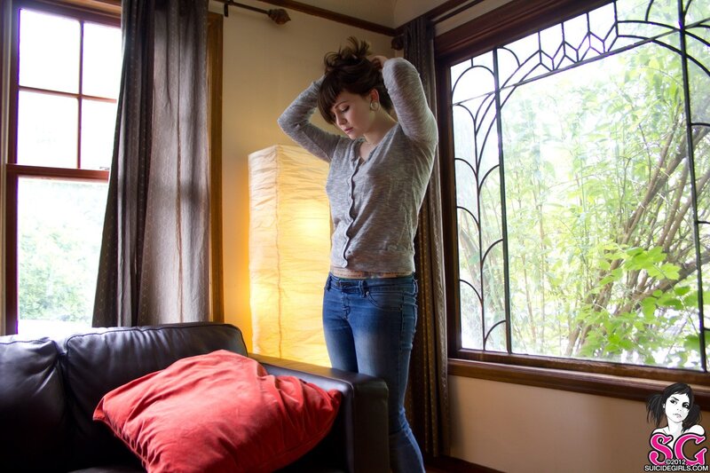 woman adjusting hair in living room