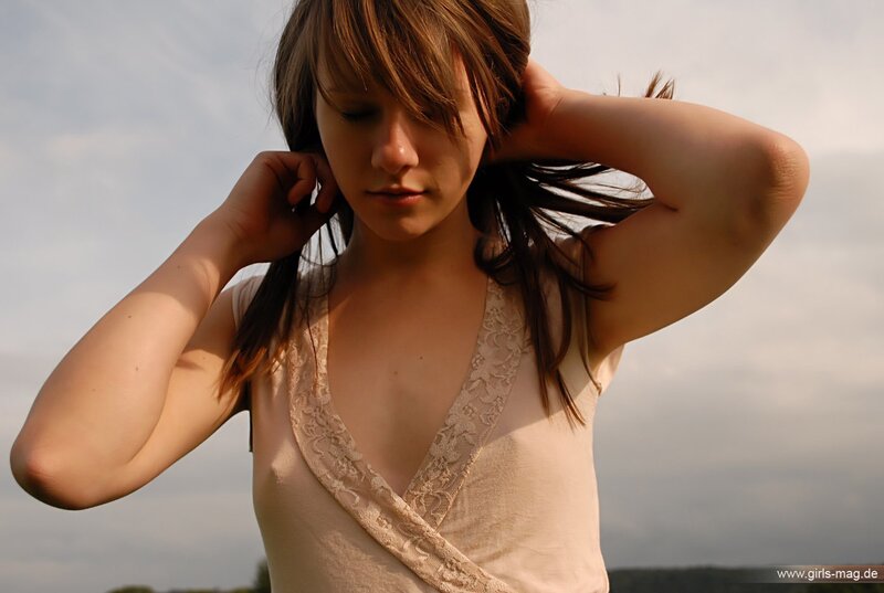 woman adjusting hair outdoors