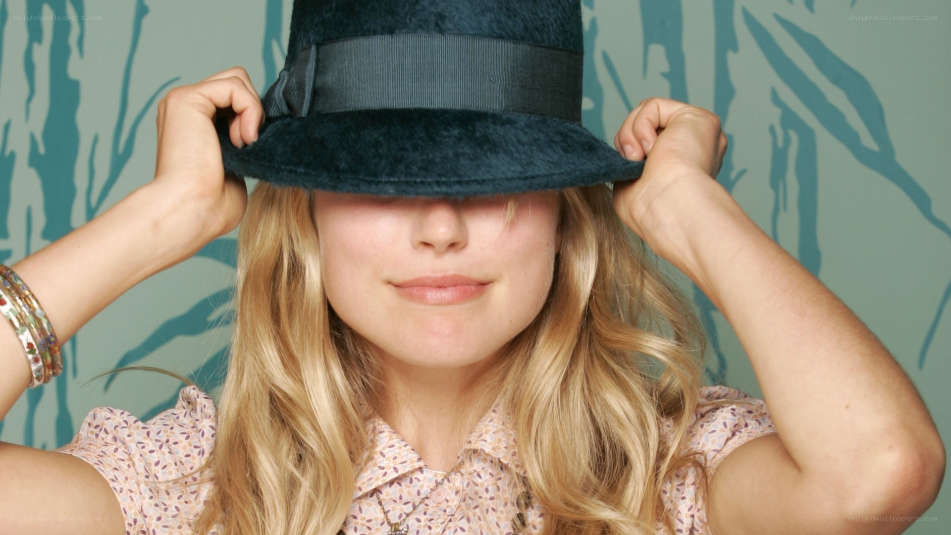 woman adjusting hat