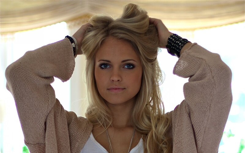 woman adjusting her hair