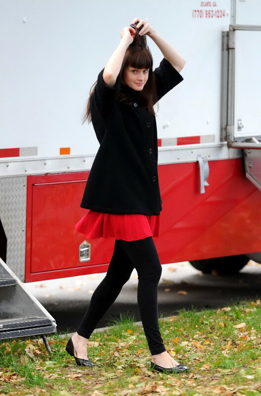 Woman adjusting her hair on set