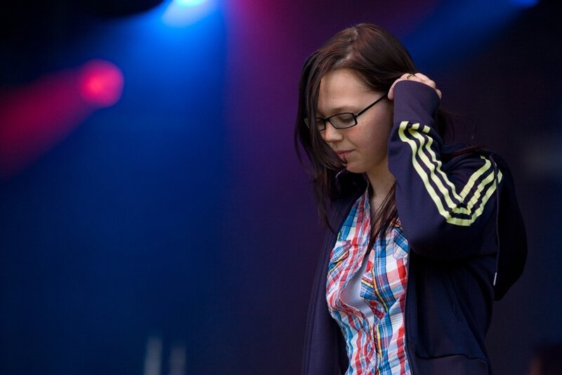 woman adjusting her hair on stage