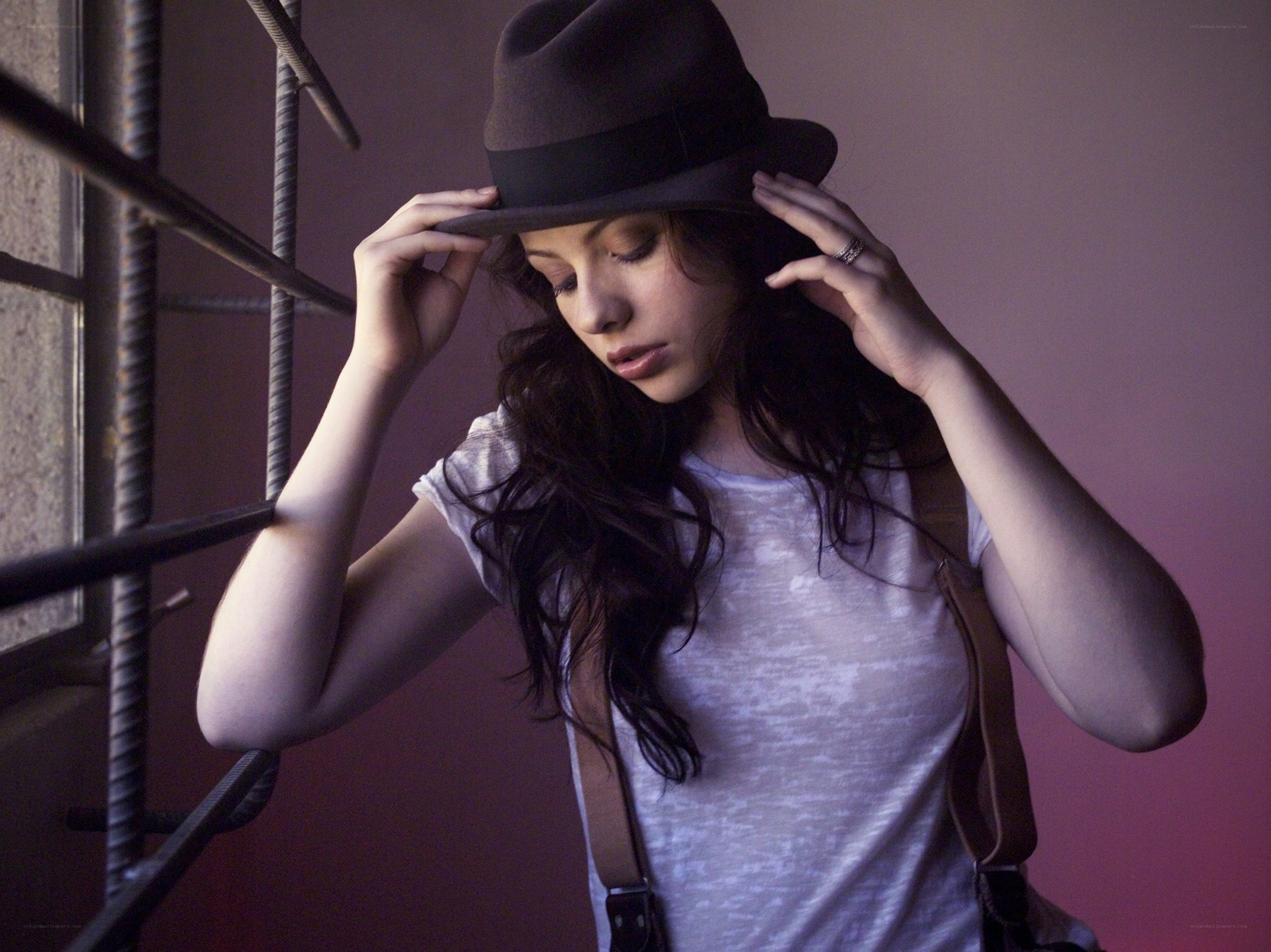 woman adjusting her hat