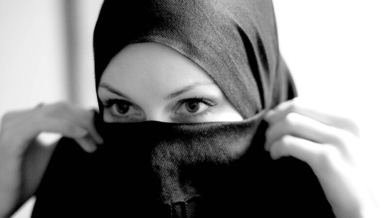 woman adjusting hijab