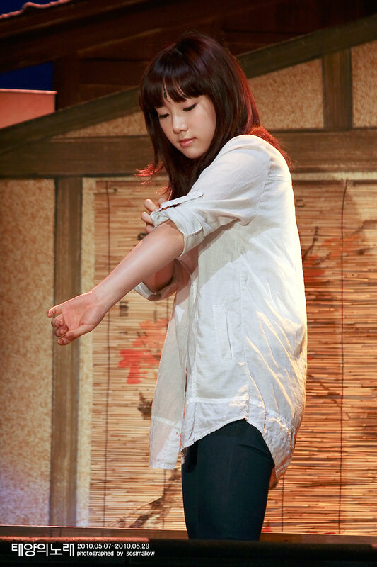 woman adjusting sleeve on stage