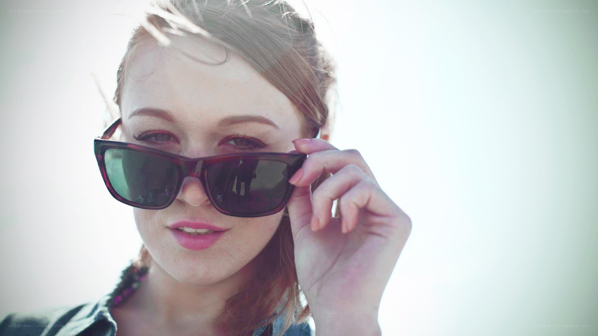 woman adjusting sunglasses
