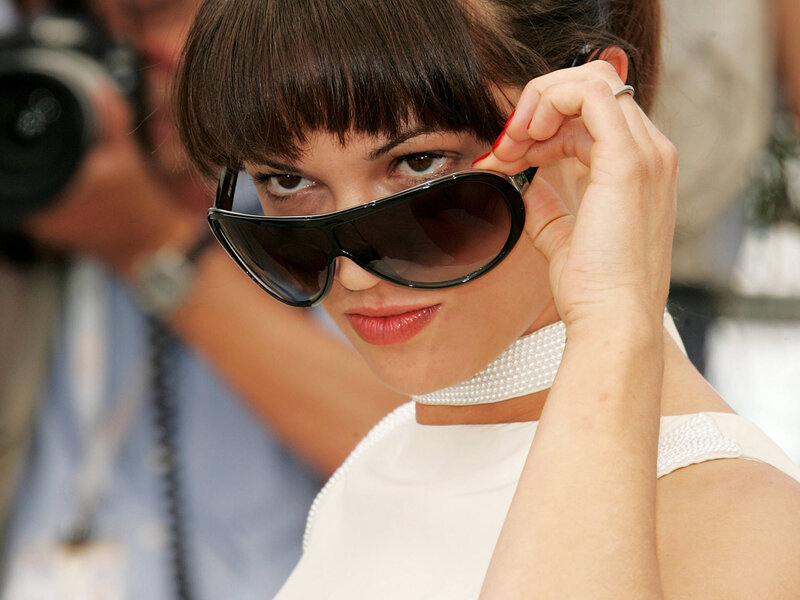 woman adjusting sunglasses