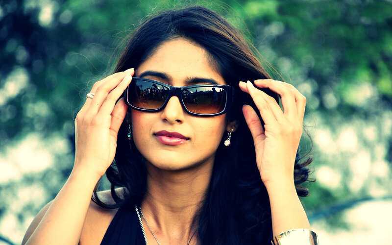 woman adjusting sunglasses outdoors