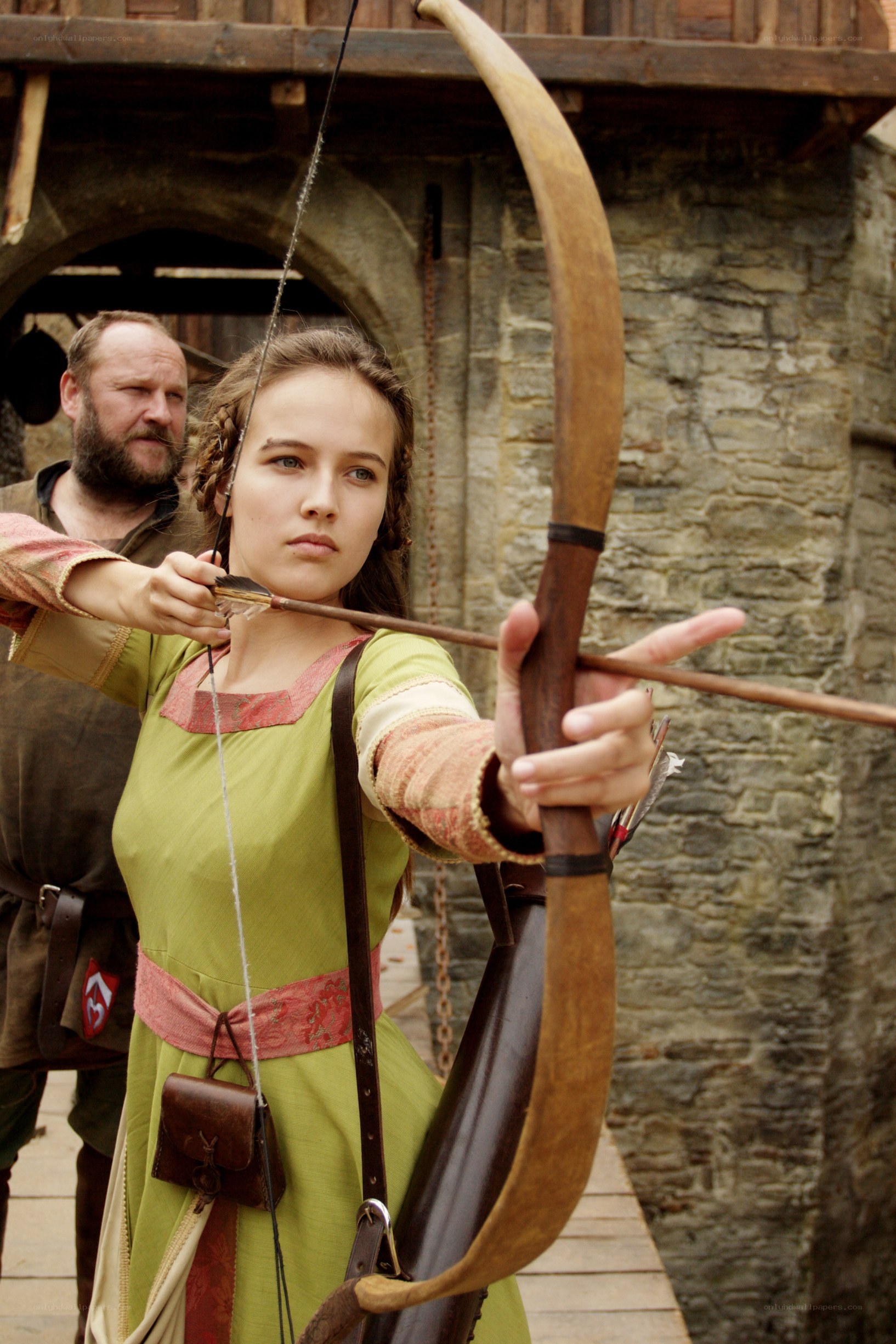 woman aiming bow and arrow
