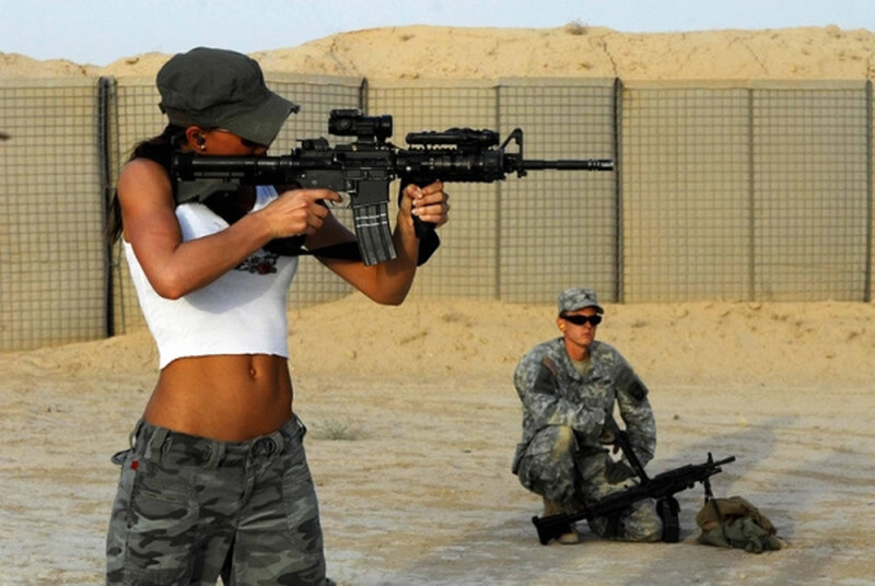 Woman aiming rifle at shooting range