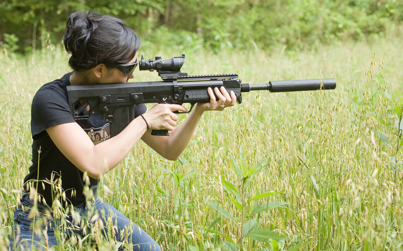 Woman Aiming Rifle — Green, Focused