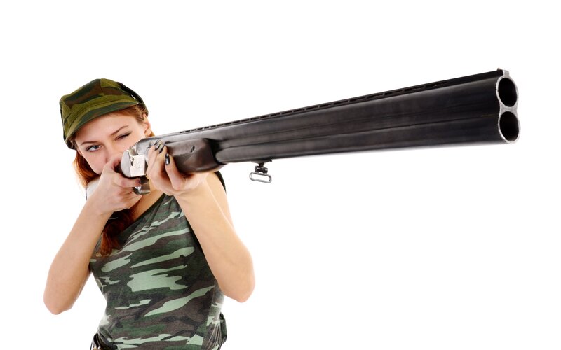 woman aiming shotgun