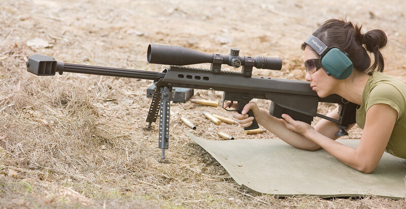 woman aiming sniper rifle