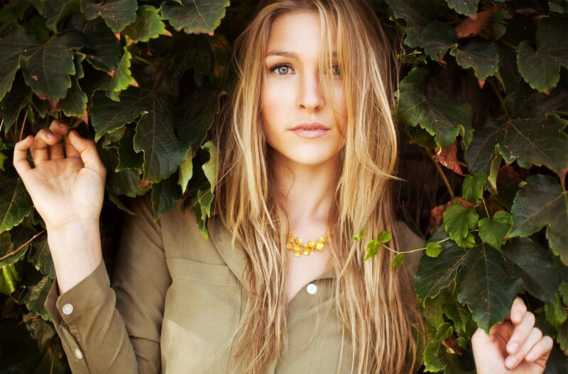 woman among green leaves