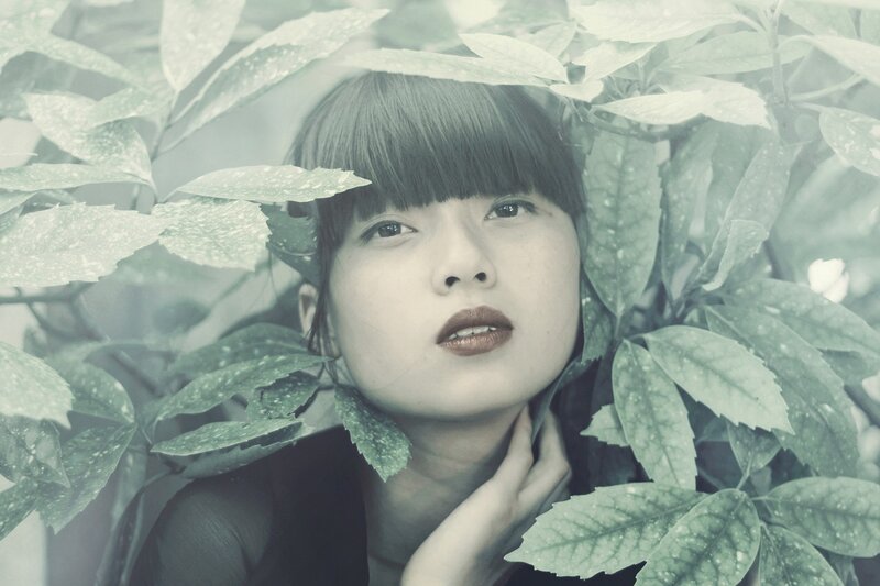 woman among green leaves
