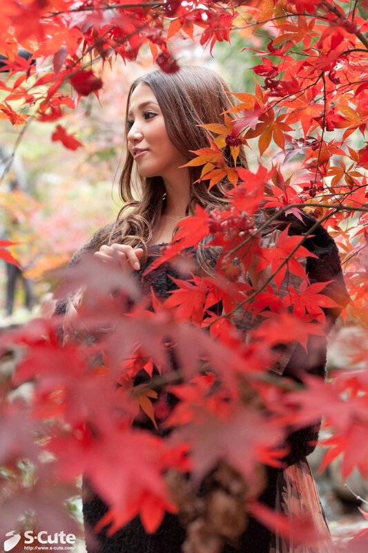 woman among red autumn leaves