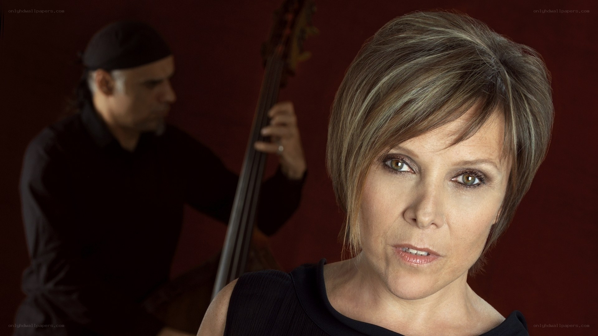 woman and bassist in studio