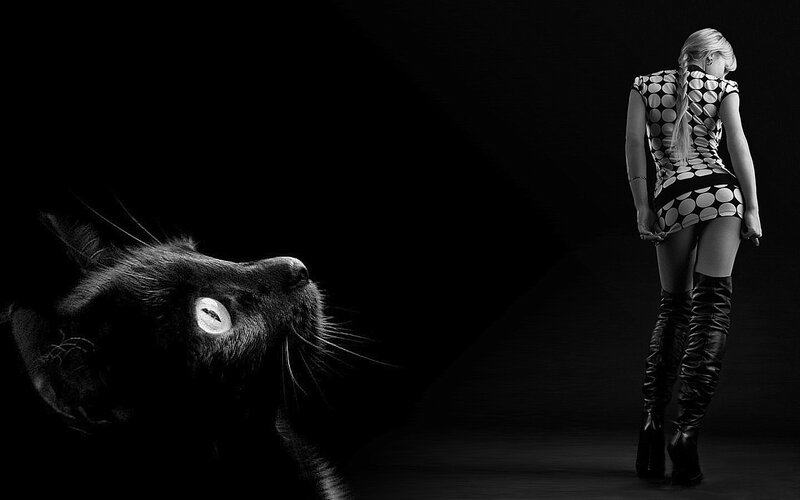 woman and black cat in dark room