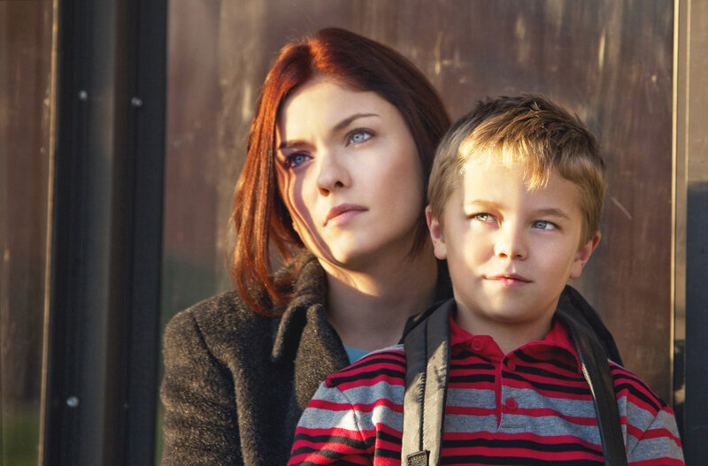 woman and boy at bus stop