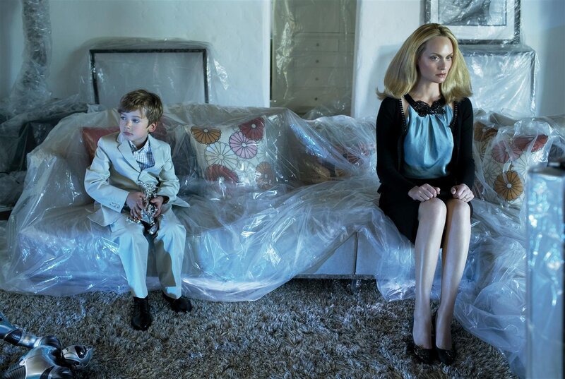 woman and boy on plastic-covered couch