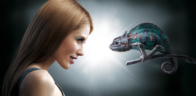 woman and chameleon in spotlight