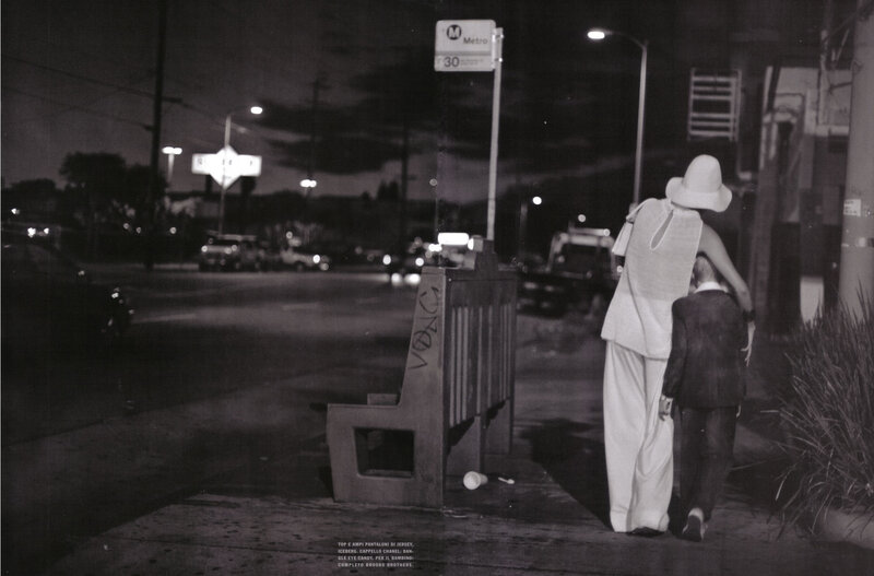 Woman and child at night bus stop
