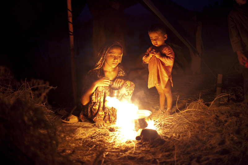 Woman and Child by Fire